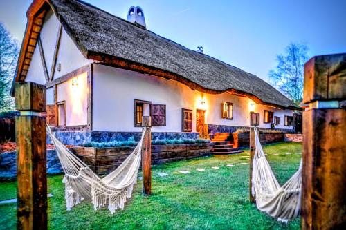 a house with two hammocks in front of it at Nature rezidence private wellness in Zahorčice