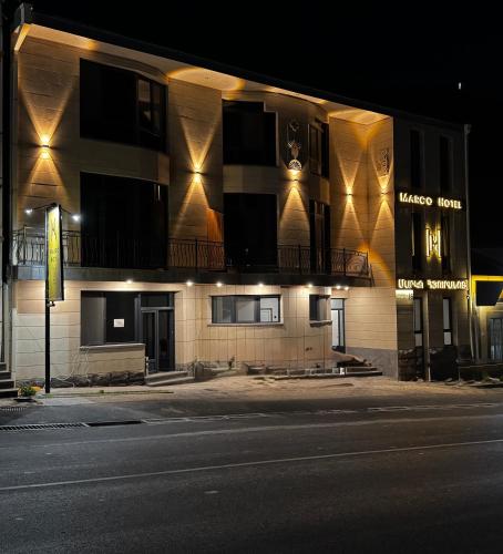 a building with lights on the side of a street at MARCO Hotel in Goris