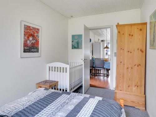 a bedroom with a bed and a dining room at Holiday Home Simon - 225m from the sea by Interhome in Klint