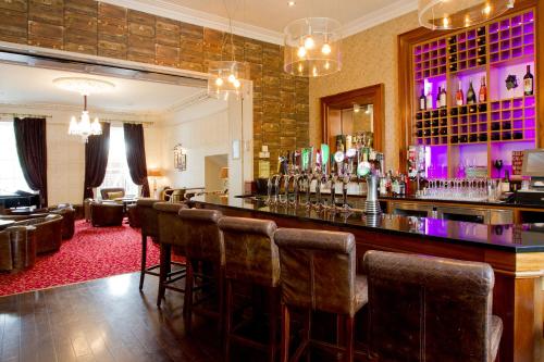 a bar in a room with a bunch of chairs at Annebrook House Hotel in Mullingar