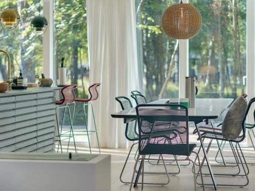 a dining room with a table and chairs in front of a window at Holiday Home Iwa - 475m from the sea by Interhome in Store Fuglede