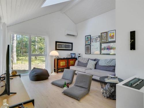 a living room with a couch and a table at Holiday Home Iwa - 475m from the sea by Interhome in Store Fuglede