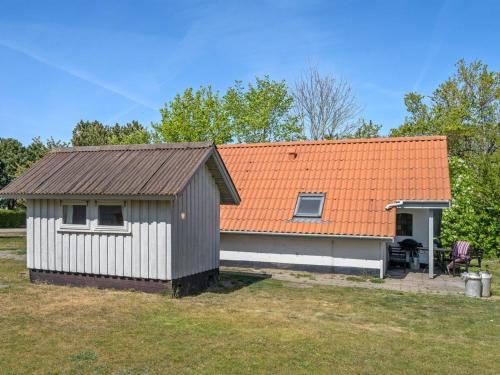 a small house with an orange roof at Holiday Home Marita - 225m from the sea by Interhome in Korsør
