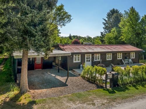 a house with a tree in front of it at Holiday Home Ilena - 16-3km from the sea by Interhome in Borup