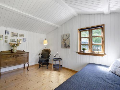 a bedroom with a bed and a desk and a window at Holiday Home Ilena - 16-3km from the sea by Interhome in Borup