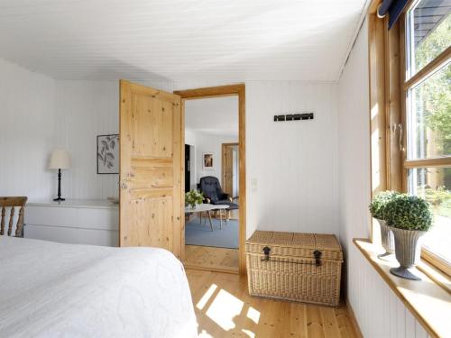 a bedroom with a bed and a room with a table at Holiday Home Ilena - 16-3km from the sea by Interhome in Borup