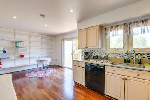 a kitchen with white cabinets and a sink and a table at Close to Hospital and Dulles Herndon Townhome in Herndon