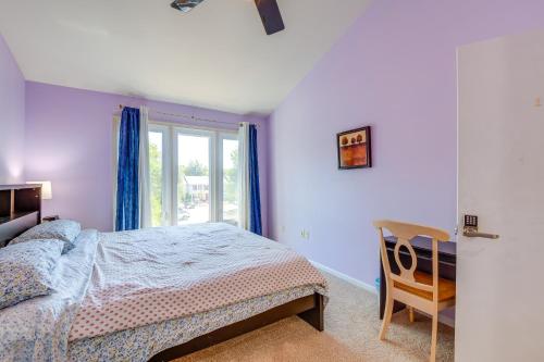 a bedroom with a bed and a window and a chair at Close to Hospital and Dulles Herndon Townhome in Herndon