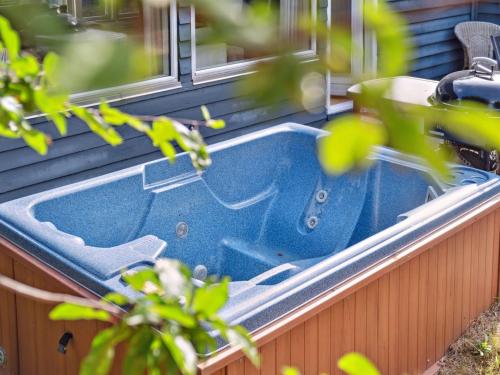 a blue bathtub sitting on the side of a house at Holiday Home Hannelore - 700m from the sea by Interhome in Nykøbing Sjælland