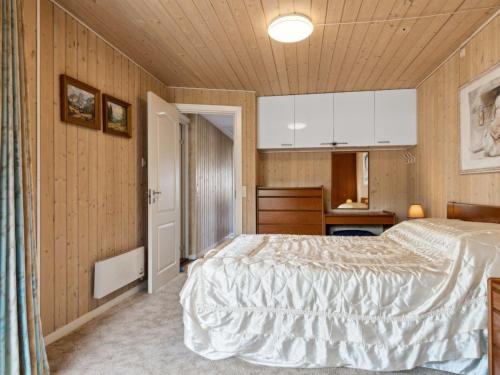 a bedroom with a bed and a wooden ceiling at Holiday Home Eleana - 300m to the fjord by Interhome in Roskilde