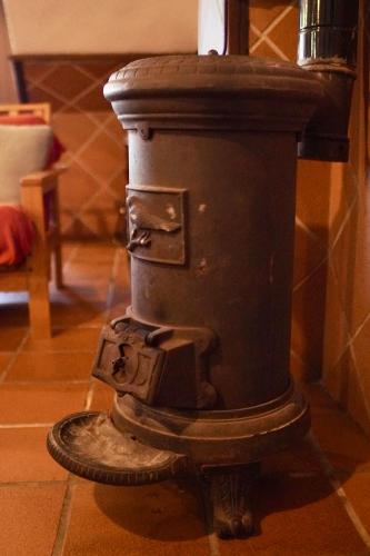 a black fire hydrant sitting on the floor at Casa Rural Sierra Tórtola 2 in Hinojales