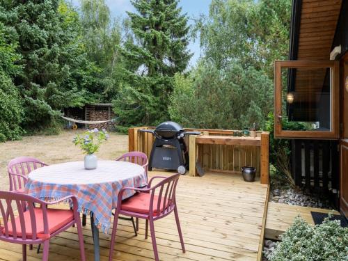a patio with a table and chairs and a grill at Holiday Home Ija - 200m from the sea by Interhome in Føllenslev