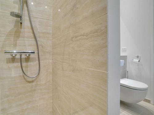 a bathroom with a shower and a toilet at Holiday Home Rikkie - 150m to the fjord by Interhome in Rørvig