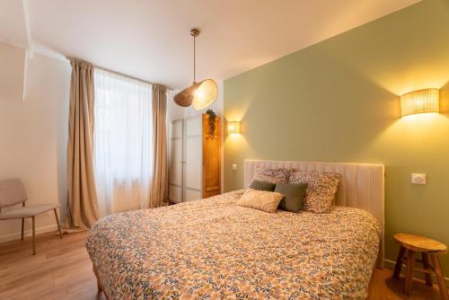 a bedroom with a large bed in a room at Rouen cœur historique in Rouen