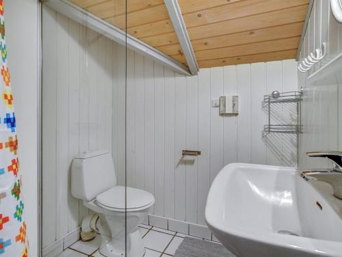 a bathroom with a toilet and a sink and a tub at Holiday Home Erly - 500m from the sea by Interhome in Nykøbing Sjælland