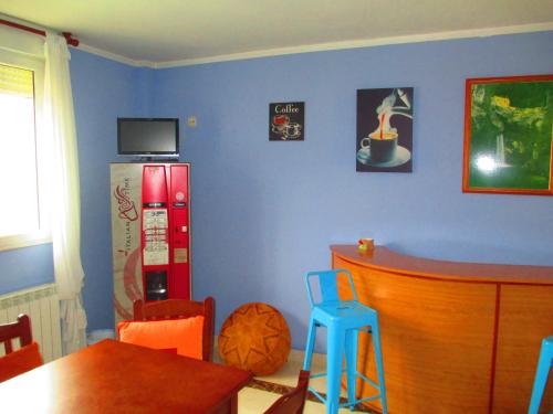 a kitchen with a blue wall with a red refrigerator at Hotel Brisas del Sella in Ribadesella