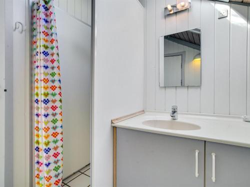 a bathroom with a sink and a mirror at Holiday Home Erly - 500m from the sea by Interhome in Nykøbing Sjælland