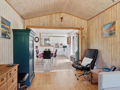 a kitchen and living room with a table and chairs at Holiday Home Ludvika - 350m from the sea by Interhome in Tjørneholm