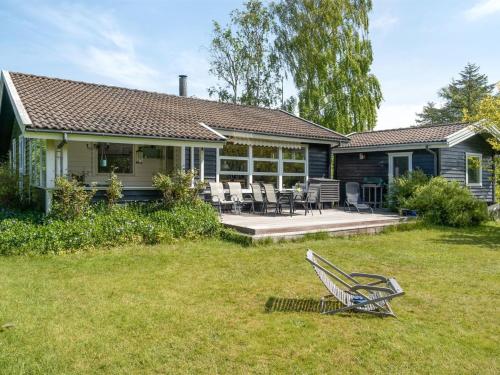 a house with a bench in the yard at Holiday Home Gærmund - 350m from the sea by Interhome in Føllenslev