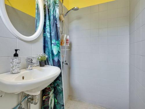 a bathroom with a sink and a shower at Holiday Home Gærmund - 350m from the sea by Interhome in Føllenslev