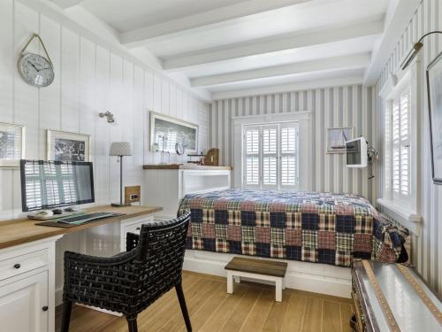 a bedroom with a bed and a desk with a computer at Holiday Home Titia - 1-2km to the inlet by Interhome in Rørvig
