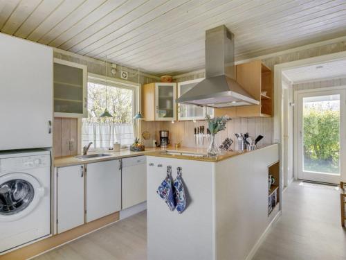 a kitchen with a sink and a stove at Holiday Home Erva - 495m from the sea by Interhome in Gedser