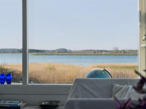 a view of a lake from a window at Holiday Home Velika - 25m to the fjord by Interhome in Grevinge