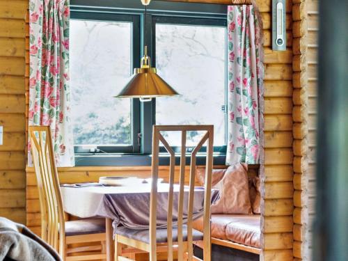 a dining room with a table and chairs and a window at Holiday Home Sander - 800m from the sea by Interhome in Højby