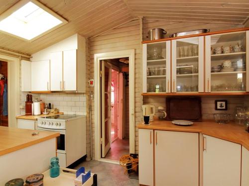 a kitchen with white cabinets and white appliances at Holiday Home Enrik - 123m from the sea by Interhome in Vordingborg