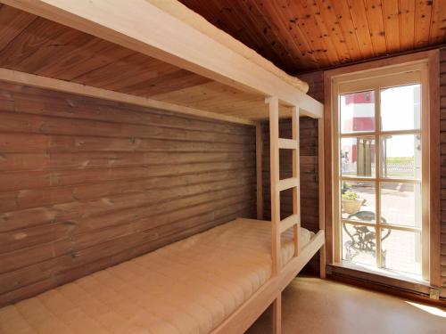 a room with a bunk bed with a window at Holiday Home Enrik - 123m from the sea by Interhome in Vordingborg