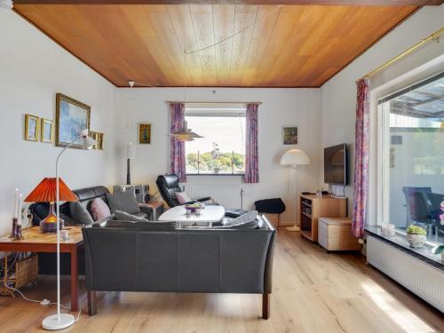 a living room with a couch and a fish tank at Holiday Home Slavjanka - 2km from the sea by Interhome in Stege