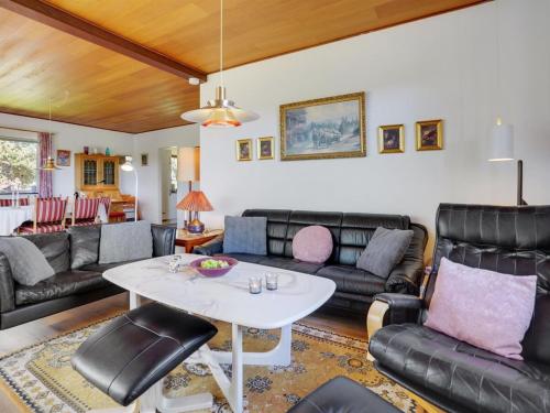 a living room with leather furniture and a table at Holiday Home Slavjanka - 2km from the sea by Interhome in Stege
