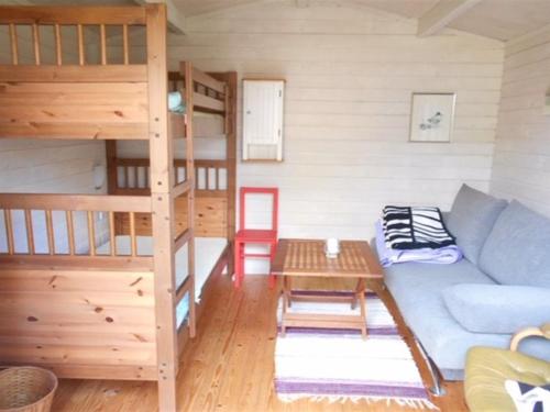 a living room with a couch and a bunk bed at Holiday Home Haldis - 120m from the sea by Interhome in Stubbekøbing