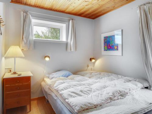 a bedroom with a bed and a window at Holiday Home Carmen - 25m from the sea by Interhome in Lumsås