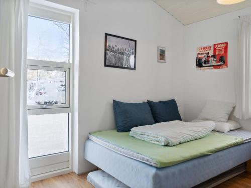 a bed in a room with a window at Holiday Home Jouni - 500m from the sea by Interhome in Gedser