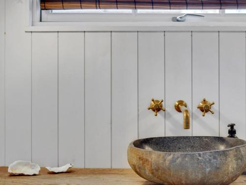 a bathroom with a large stone sink on a table at Holiday Home Mojsej by Interhome in Slagelse