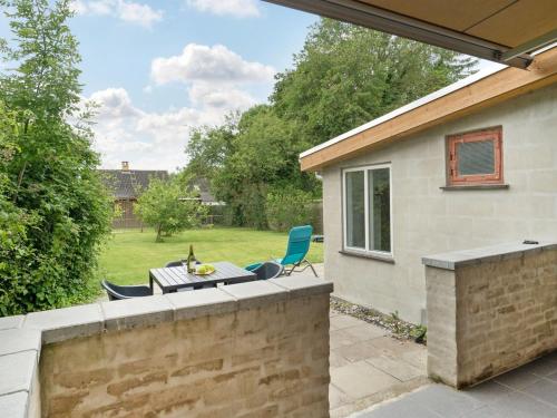 a patio with a table and chairs in a yard at Holiday Home Feikje - 5-5km from the sea by Interhome in Rødby