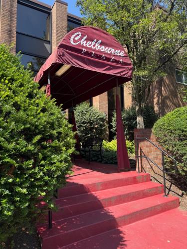a red umbrella on the steps of a building at Spacious 2br2ba Firstfloor Condo in Jenkintown