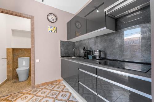 a kitchen with a sink and a toilet at Antique Spanish Villa With A Patio in Guardamar del Segura