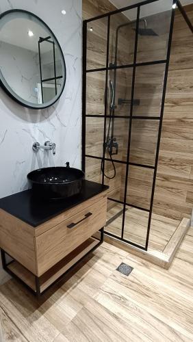 a bathroom with a black sink and a mirror at Comfort Corner Spacious & Quiet 2BR Apartment in Thessaloniki in Thessaloniki