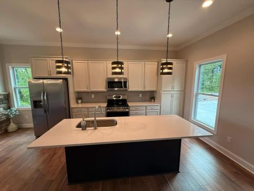a kitchen with a sink and a refrigerator at The Overlook at Lake James in Nebo