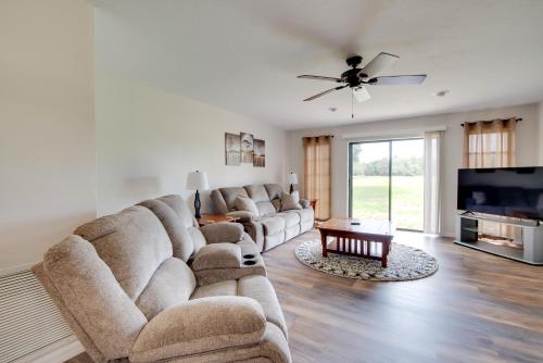 a living room with a large couch and a flat screen tv at Walk to Lake Geataway with Yard in Inverness in Inverness