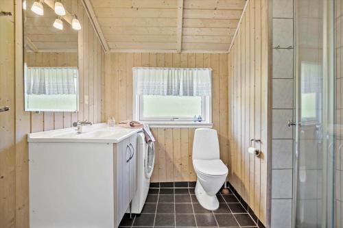 a bathroom with a toilet and a sink and a shower at JB223-Brovst-Kronvildtvej-18 in Tranum