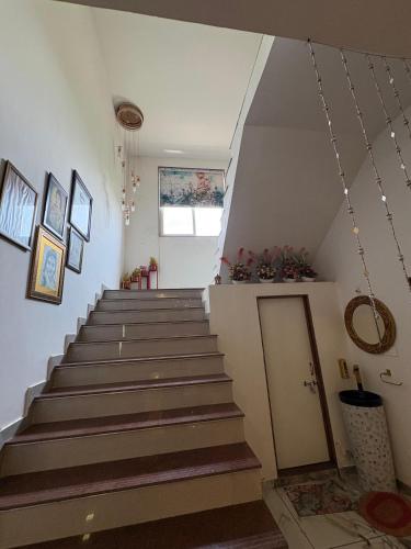 a staircase in a house with a stair case at Gift city farmhouse in Gandhinagar