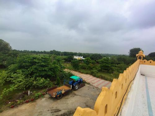 a truck parked on the side of a wall at Gift city farmhouse in Gandhinagar