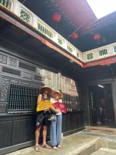 a couple of people standing in a building at Sala Hoi An Hotel in Hoi An