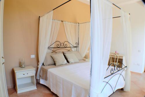 a bedroom with a bed with a canopy at Montammare Casa Di Charme in Tramonti