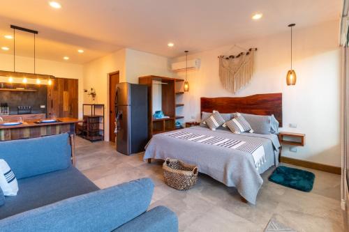 a bedroom with a large bed and a kitchen at TULUM XAMIRA PRIVATE SPA Balcony in Tulum