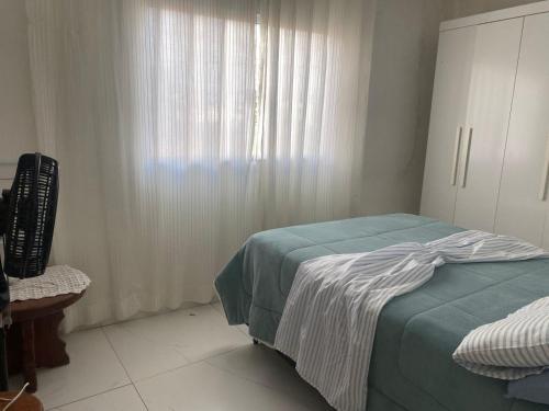 a bedroom with a bed and a window at Villa Zilá in Vila Velha