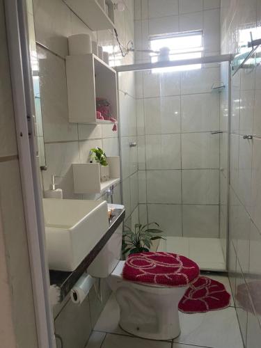 a bathroom with a toilet and a sink and a shower at Villa Zilá in Vila Velha